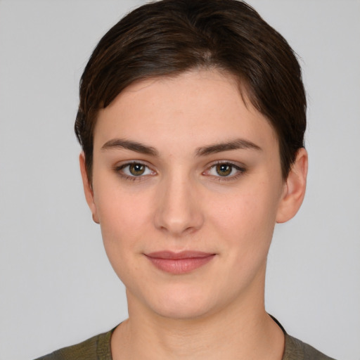 Joyful white young-adult female with short  brown hair and brown eyes