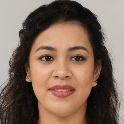 Joyful latino young-adult female with long  brown hair and brown eyes