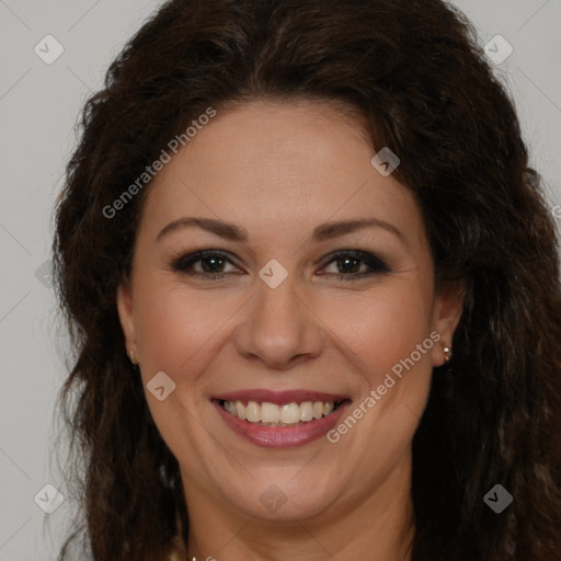 Joyful white adult female with long  brown hair and brown eyes