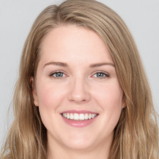 Joyful white young-adult female with long  brown hair and blue eyes