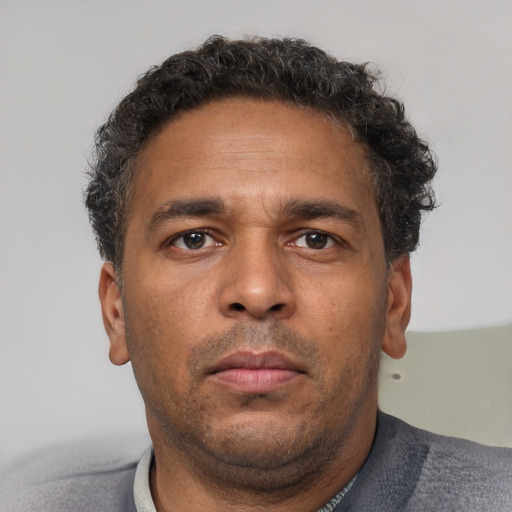 Neutral latino young-adult male with short  brown hair and brown eyes