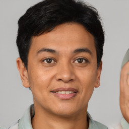 Joyful asian young-adult male with short  brown hair and brown eyes