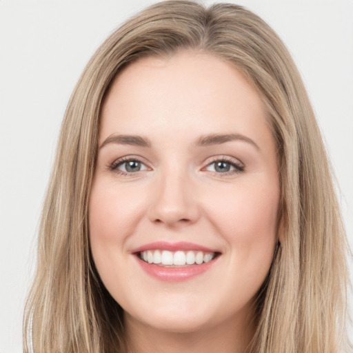 Joyful white young-adult female with long  brown hair and green eyes