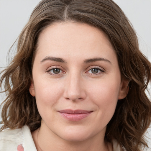 Joyful white young-adult female with medium  brown hair and green eyes