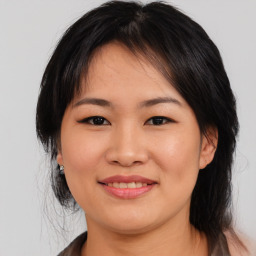 Joyful asian young-adult female with medium  black hair and brown eyes