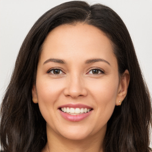 Joyful white young-adult female with long  brown hair and brown eyes