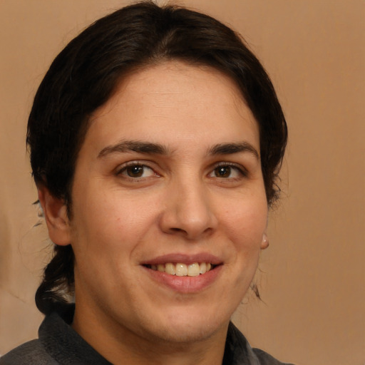 Joyful white adult female with medium  brown hair and brown eyes