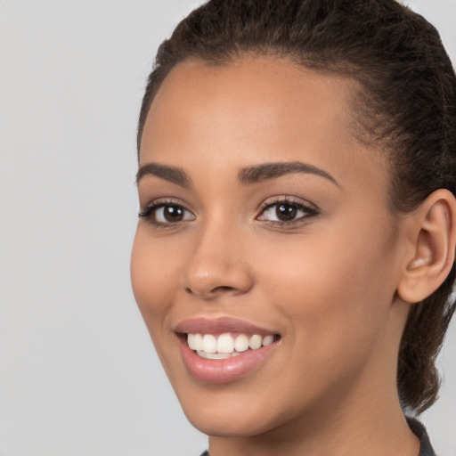 Joyful white young-adult female with long  brown hair and brown eyes