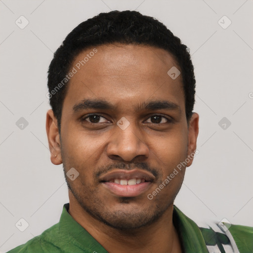 Joyful black young-adult male with short  black hair and brown eyes