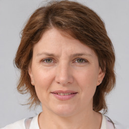 Joyful white adult female with medium  brown hair and grey eyes