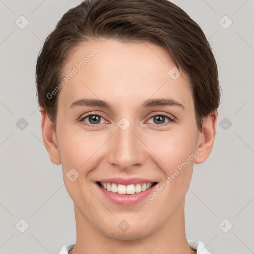 Joyful white young-adult female with short  brown hair and grey eyes