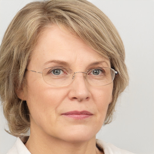 Joyful white middle-aged female with medium  brown hair and grey eyes