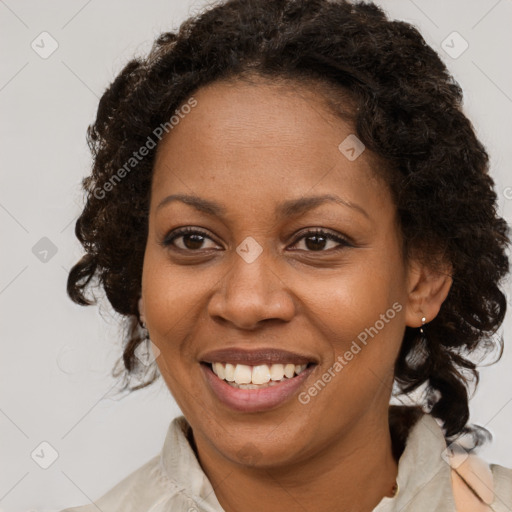 Joyful black adult female with medium  brown hair and brown eyes