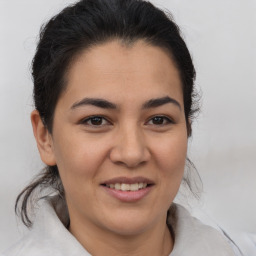 Joyful latino young-adult female with medium  brown hair and brown eyes