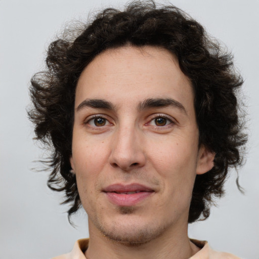 Joyful white young-adult male with medium  brown hair and brown eyes