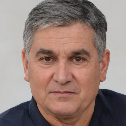 Joyful white middle-aged male with short  black hair and brown eyes