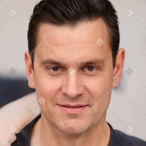 Joyful white adult male with short  brown hair and brown eyes