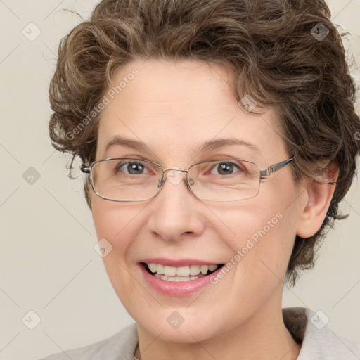 Joyful white adult female with medium  brown hair and green eyes