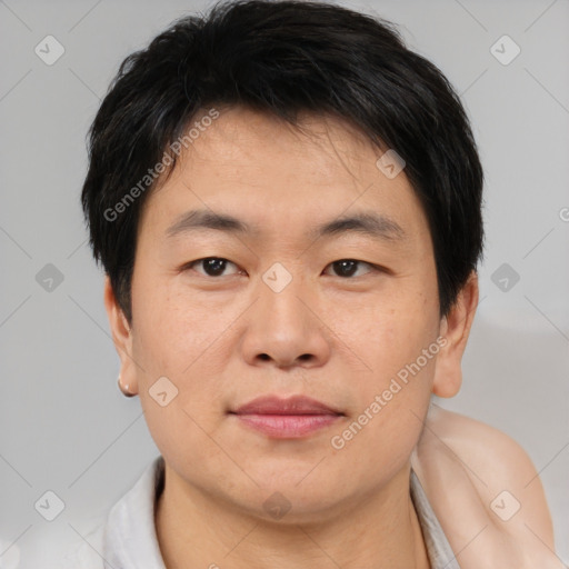 Joyful asian young-adult male with short  brown hair and brown eyes