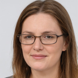 Joyful white adult female with long  brown hair and brown eyes