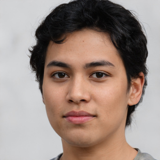 Joyful latino young-adult male with medium  brown hair and brown eyes