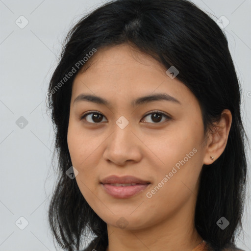 Joyful latino young-adult female with long  brown hair and brown eyes