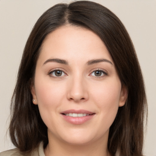 Joyful white young-adult female with medium  brown hair and brown eyes