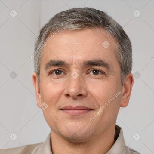 Joyful white adult male with short  brown hair and brown eyes