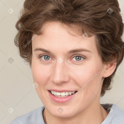 Joyful white young-adult female with medium  brown hair and blue eyes