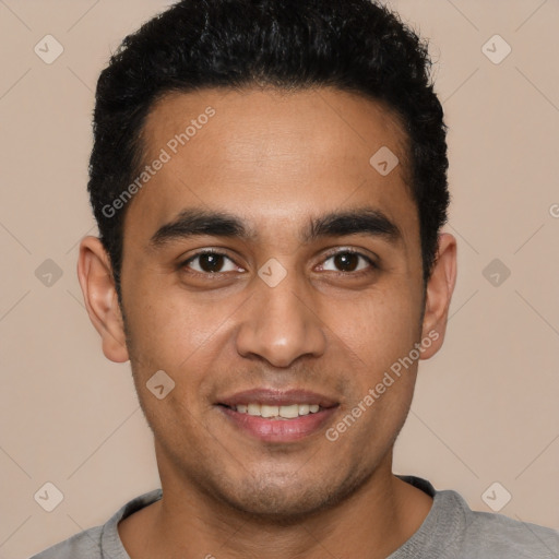 Joyful latino young-adult male with short  black hair and brown eyes