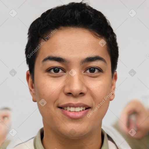 Joyful latino young-adult male with short  black hair and brown eyes