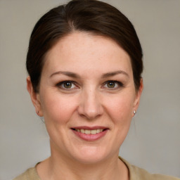 Joyful white adult female with medium  brown hair and grey eyes