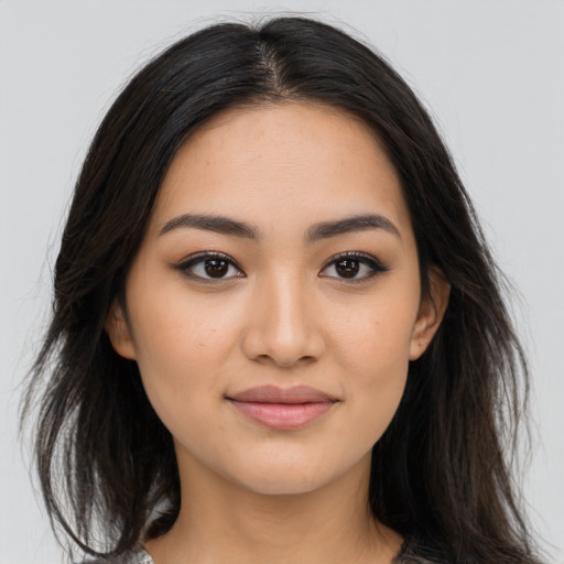 Joyful asian young-adult female with long  brown hair and brown eyes