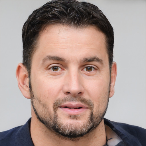 Joyful white adult male with short  brown hair and brown eyes