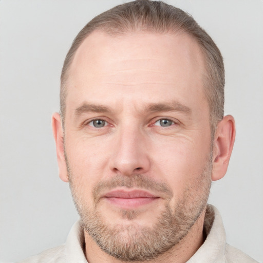 Joyful white adult male with short  brown hair and grey eyes