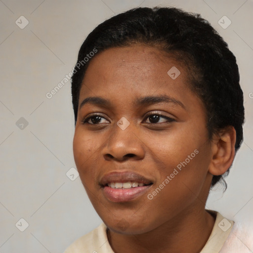 Joyful black young-adult female with short  black hair and brown eyes