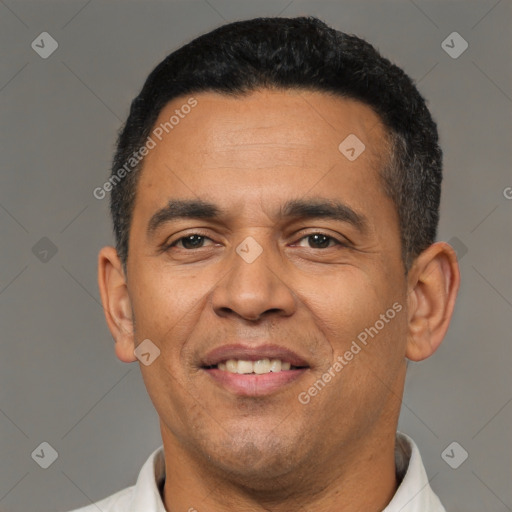 Joyful latino adult male with short  black hair and brown eyes