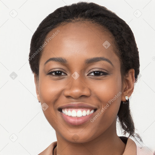 Joyful black young-adult female with long  brown hair and brown eyes