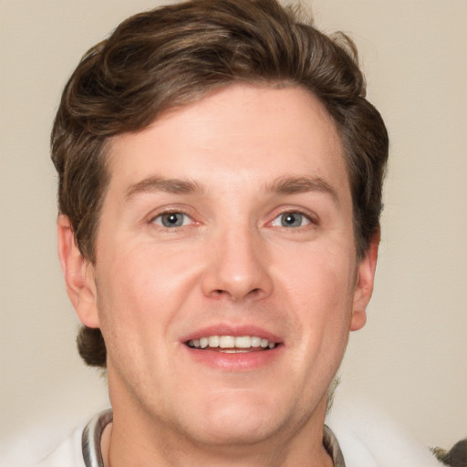 Joyful white adult male with short  brown hair and grey eyes