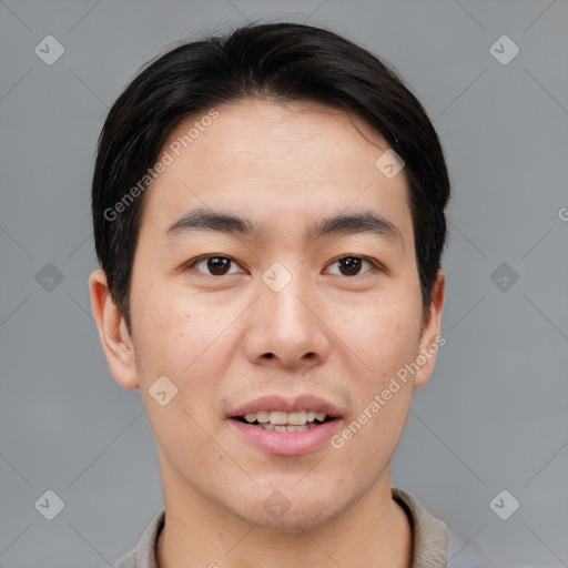 Joyful asian young-adult male with short  brown hair and brown eyes