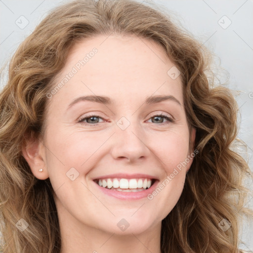 Joyful white young-adult female with long  brown hair and blue eyes