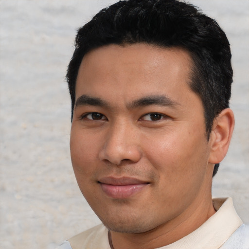Joyful asian young-adult male with short  black hair and brown eyes