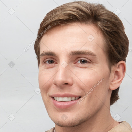 Joyful white young-adult male with short  brown hair and grey eyes