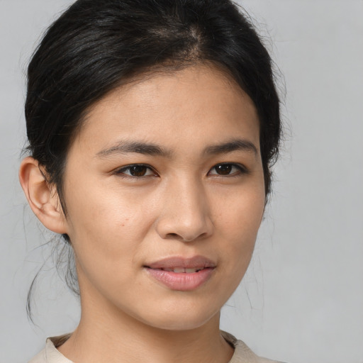 Joyful asian young-adult female with medium  brown hair and brown eyes