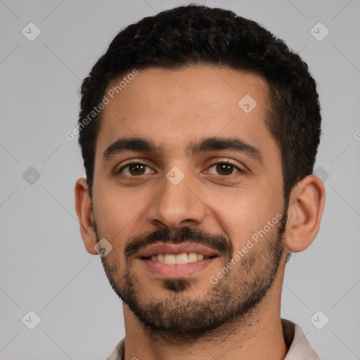 Joyful latino young-adult male with short  black hair and brown eyes