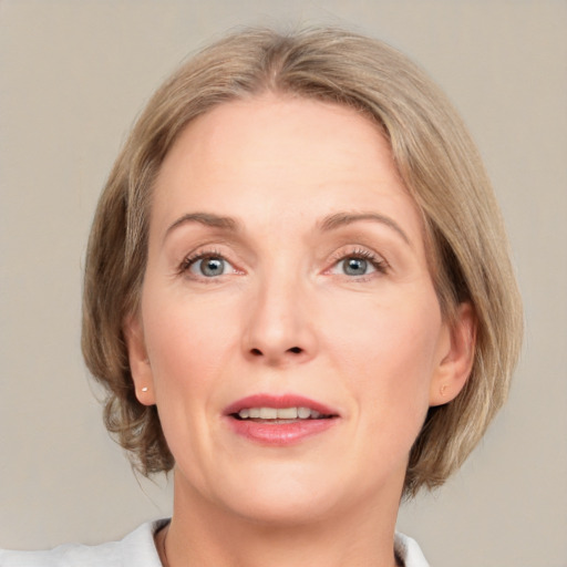 Joyful white adult female with medium  brown hair and grey eyes