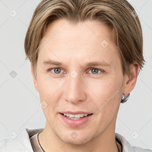 Joyful white young-adult female with short  brown hair and grey eyes