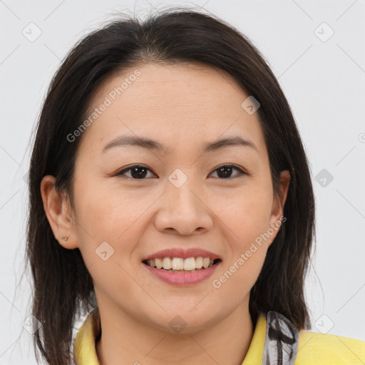 Joyful latino young-adult female with medium  brown hair and brown eyes