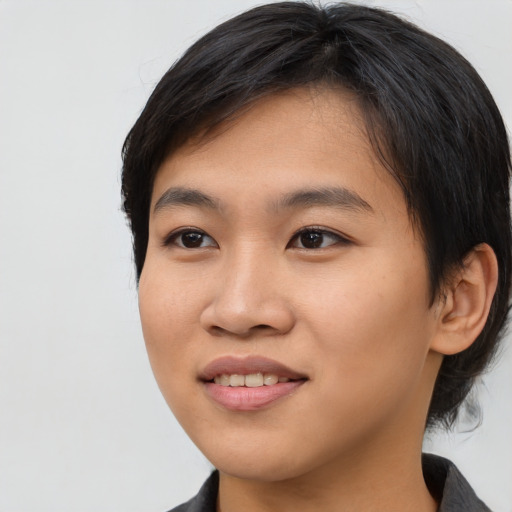 Joyful asian young-adult female with medium  black hair and brown eyes