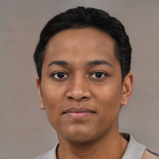 Joyful black young-adult male with short  black hair and brown eyes